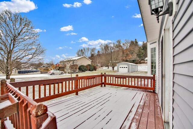 snow covered deck with an outbuilding