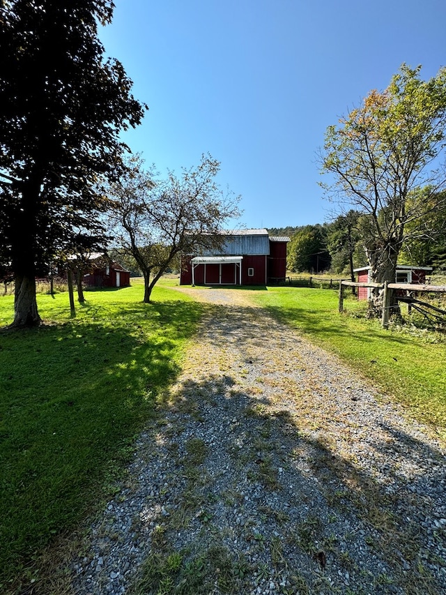 view of yard with an outbuilding and a rural view