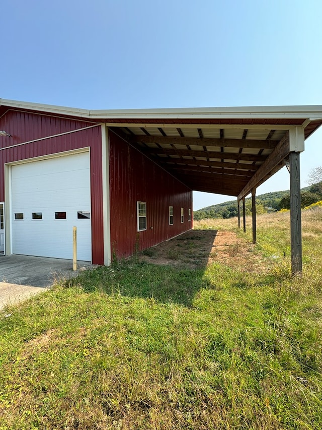 view of outbuilding with a garage and a yard