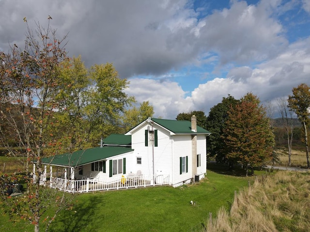 rear view of property featuring a yard