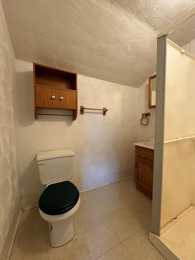 bathroom with vanity, toilet, and vaulted ceiling