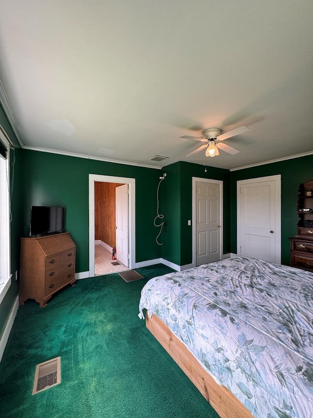 carpeted bedroom with ceiling fan and crown molding