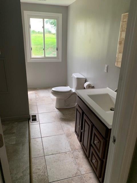 bathroom featuring vanity and toilet