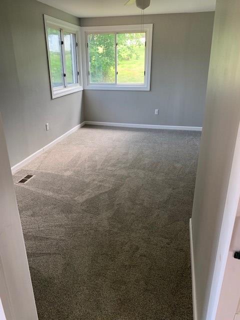 carpeted empty room with ceiling fan