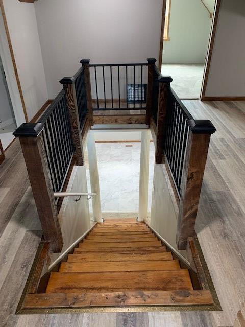 stairs with wood-type flooring