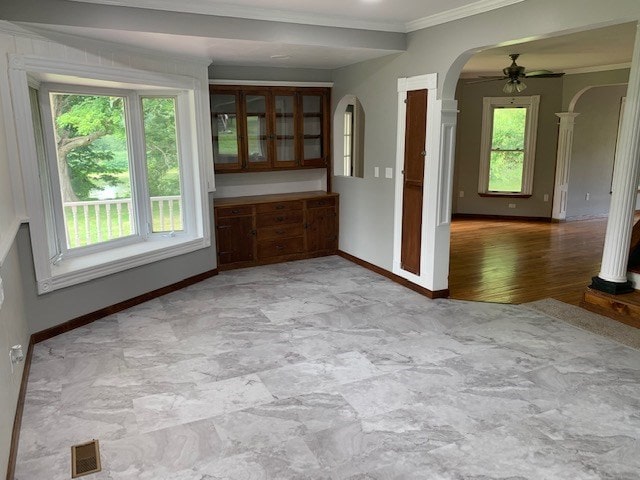 interior space featuring ceiling fan and crown molding