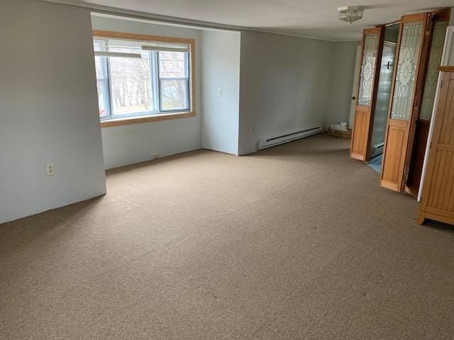 unfurnished room featuring light colored carpet and a baseboard heating unit