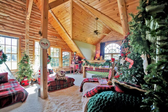 carpeted living room featuring beam ceiling, rustic walls, ceiling fan, high vaulted ceiling, and wood ceiling