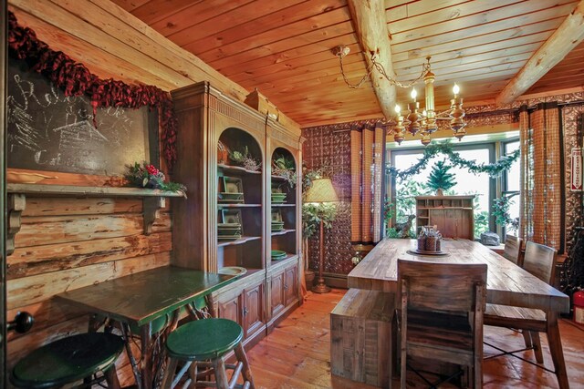 dining room with beamed ceiling, wooden ceiling, and an inviting chandelier