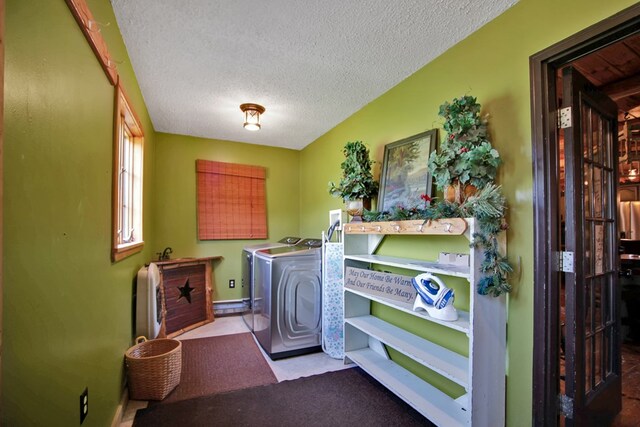 laundry room featuring independent washer and dryer and a textured ceiling