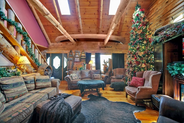 living room featuring vaulted ceiling with beams, wooden ceiling, and hardwood / wood-style flooring