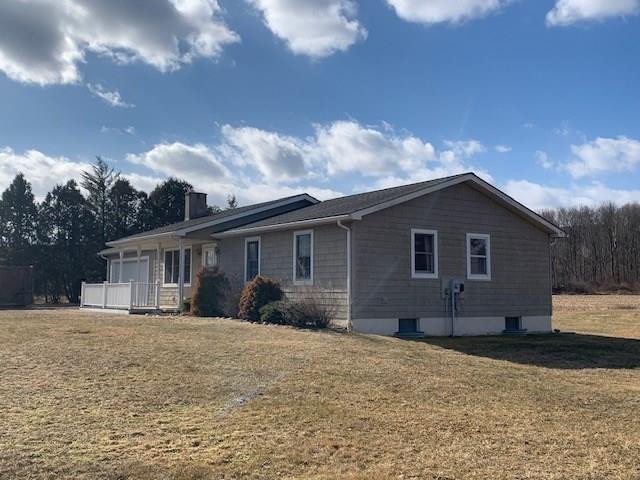 view of front of home with a garage and a front lawn