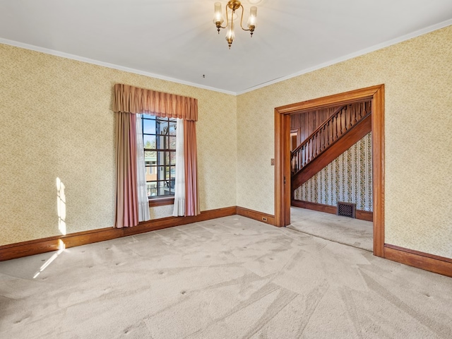 unfurnished room with carpet flooring, crown molding, and a chandelier