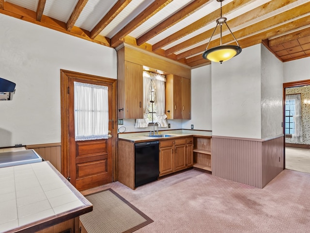 kitchen with dishwasher, light carpet, sink, decorative light fixtures, and tile counters