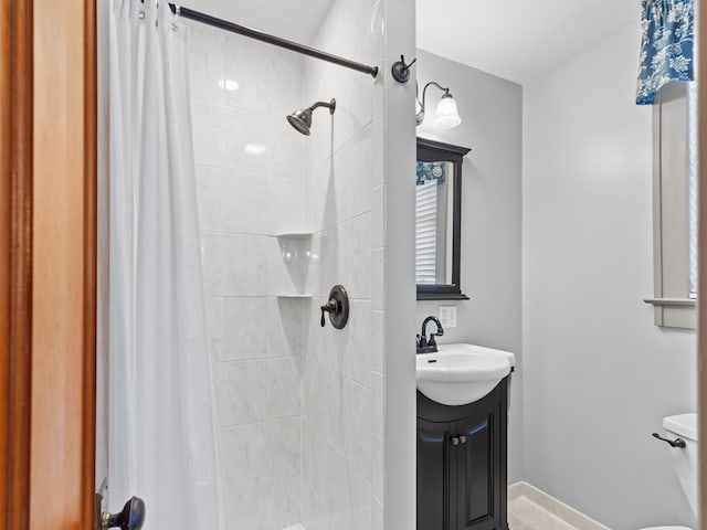 bathroom with vanity, toilet, and walk in shower