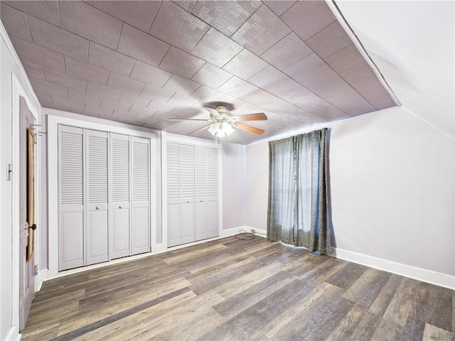 712 W Main St, Smethport, PA 16749 - unfurnished bedroom with wood finished floors, multiple closets, baseboards, and a ceiling fan
