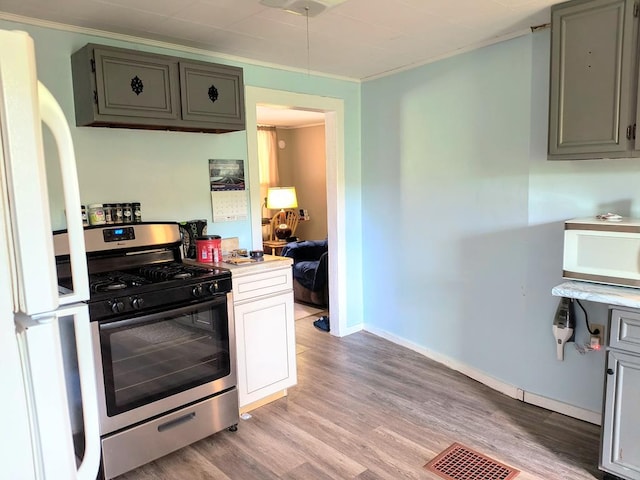 2826 Austinville Rd, Troy, PA 16947 - kitchen featuring white appliances, light wood-style flooring, gray cabinetry, crown molding, and light countertops