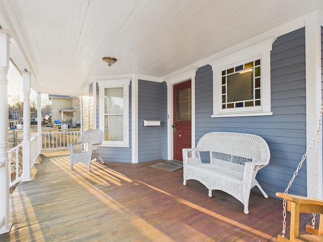 wooden terrace featuring covered porch