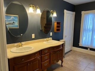 bathroom featuring tile patterned flooring and vanity