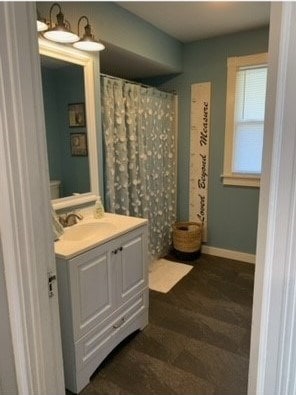 bathroom with a shower with shower curtain and vanity