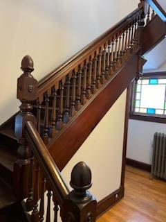 stairway featuring wood-type flooring and radiator heating unit