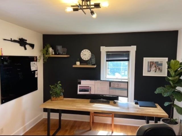 office space with hardwood / wood-style floors and a notable chandelier