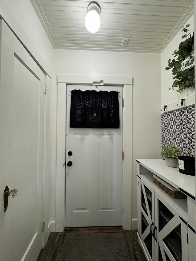 doorway with dark hardwood / wood-style flooring and wooden ceiling