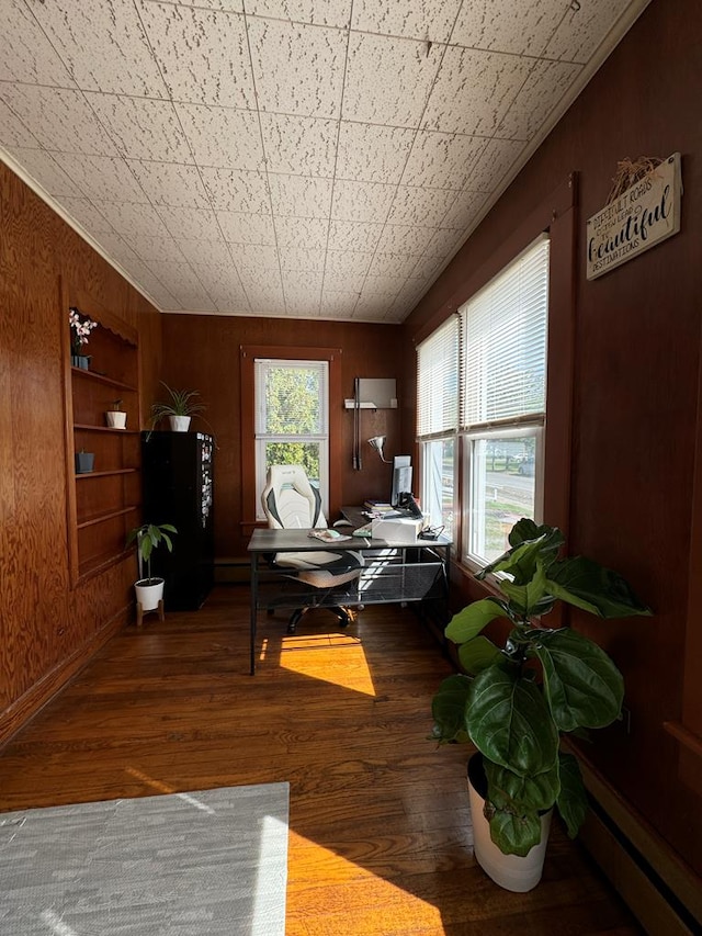 interior space with wood-type flooring, a wealth of natural light, wooden walls, and built in shelves