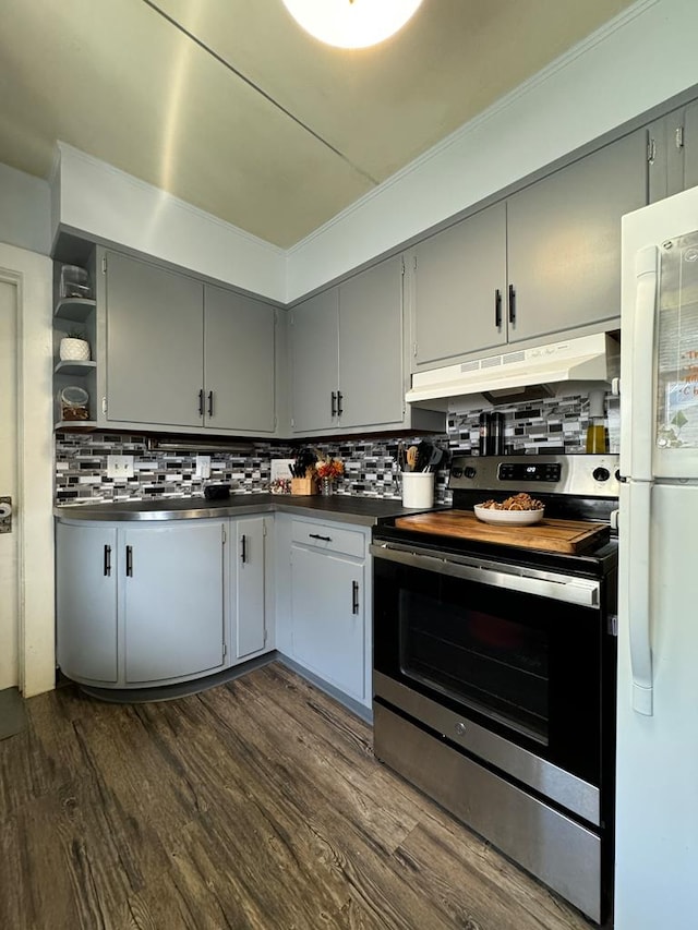 kitchen featuring backsplash, dark wood-type flooring, white fridge, and stainless steel electric range oven