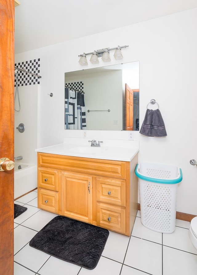 full bathroom featuring toilet, vanity, and tile patterned flooring