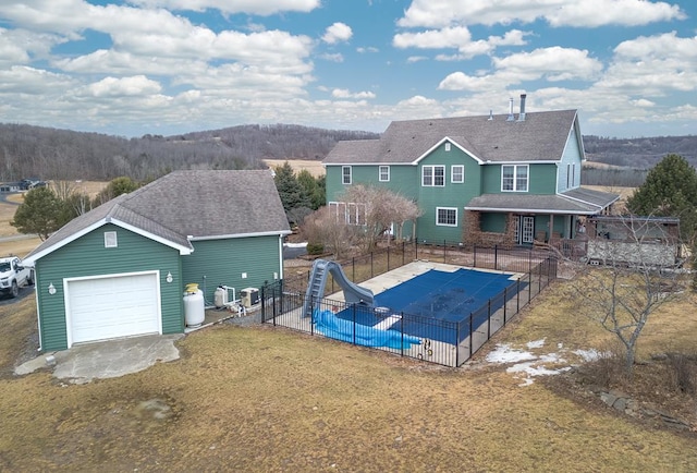 view of swimming pool with a fenced in pool, fence, a water slide, a yard, and a patio area