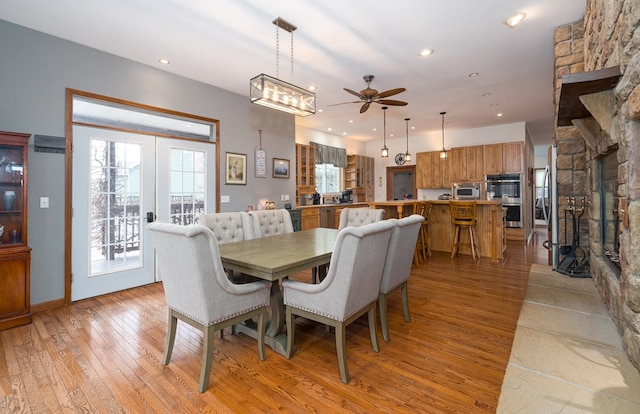 dining room with recessed lighting, light wood-type flooring, a ceiling fan, and french doors