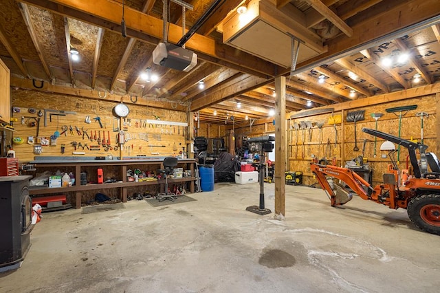 garage with a workshop area and a garage door opener