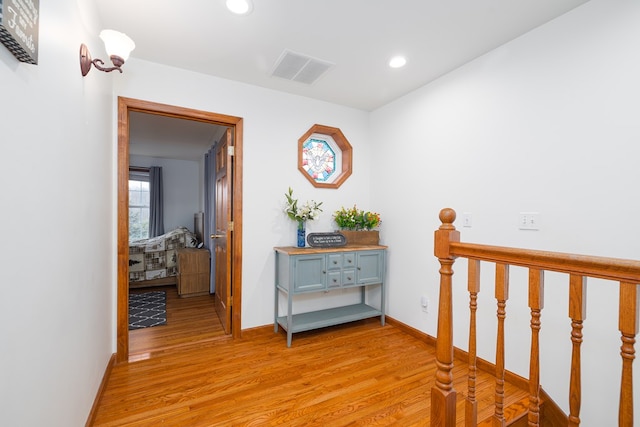 corridor with recessed lighting, visible vents, baseboards, and light wood-style floors