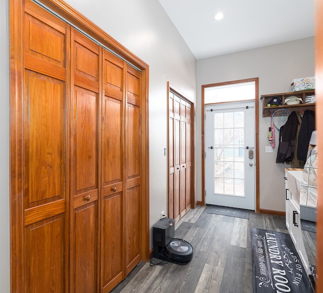 mudroom with dark wood-type flooring and baseboards