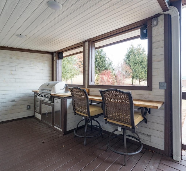 wooden terrace with a grill and exterior kitchen