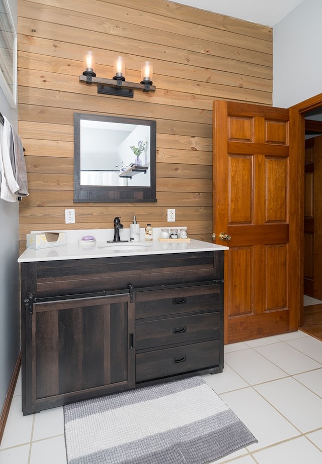 bathroom with tile patterned floors, wood walls, and vanity