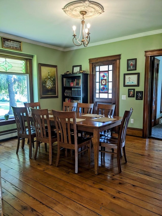 dining area featuring a wealth of natural light, dark hardwood / wood-style floors, and an inviting chandelier