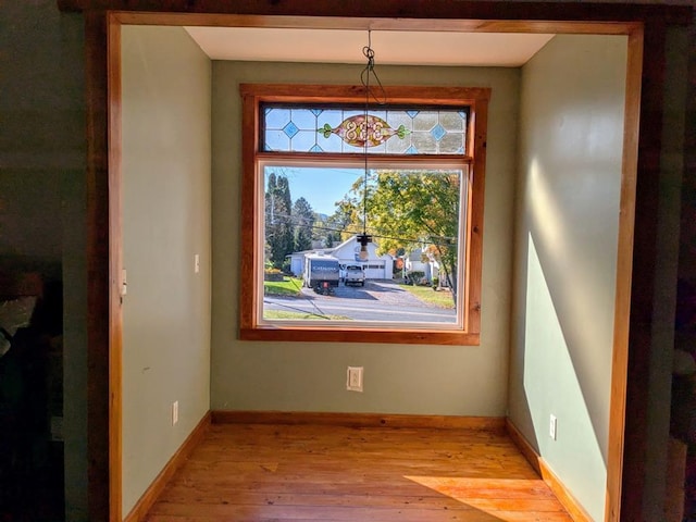 interior space with hardwood / wood-style flooring and a chandelier