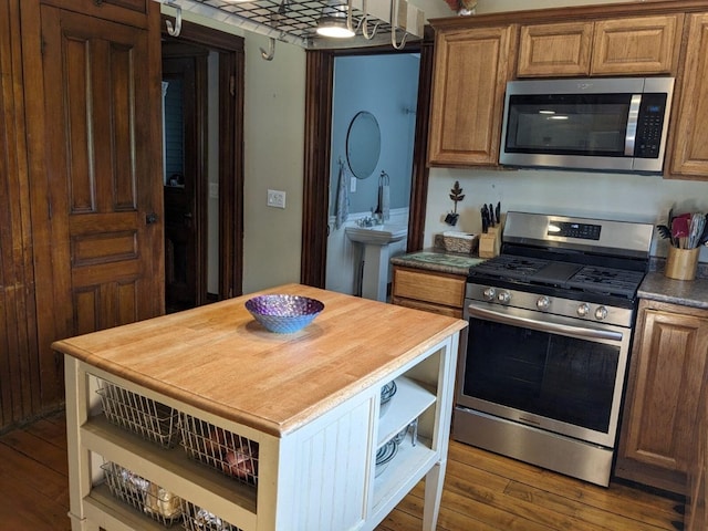 kitchen with butcher block counters, wood-type flooring, and stainless steel appliances