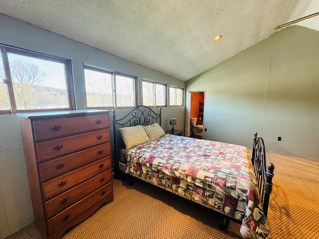 bedroom featuring vaulted ceiling, light carpet, and a textured ceiling