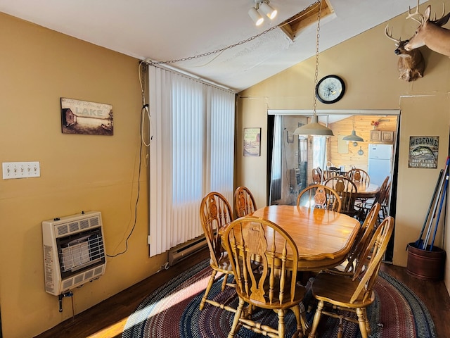 dining room featuring lofted ceiling, dark wood-type flooring, and heating unit