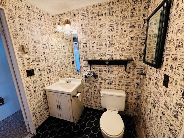 bathroom featuring vanity, tile patterned floors, and toilet