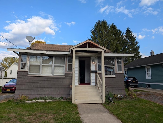 bungalow-style home featuring a front yard