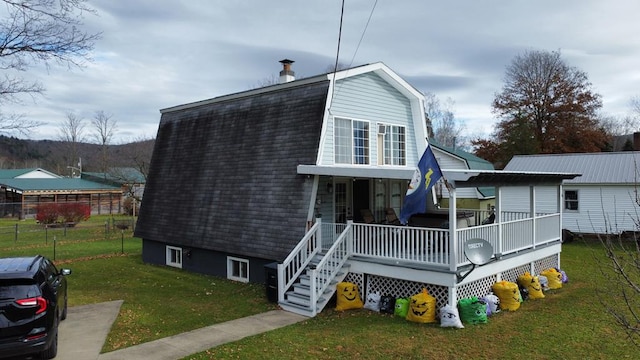 view of front of house with covered porch and a front yard