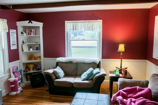 living room with hardwood / wood-style floors and beamed ceiling