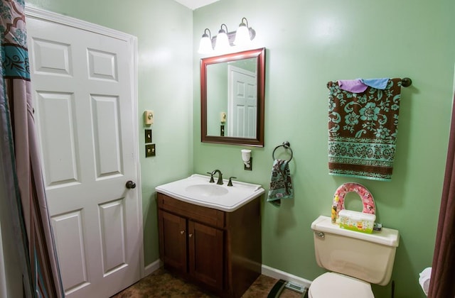 bathroom featuring vanity and toilet