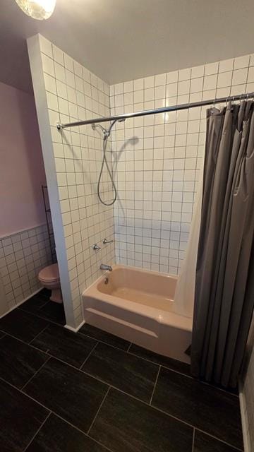 306 Broad St, Port Allegany, PA 16743 - bathroom featuring tile walls, shower / bath combo, a wainscoted wall, and tile patterned flooring