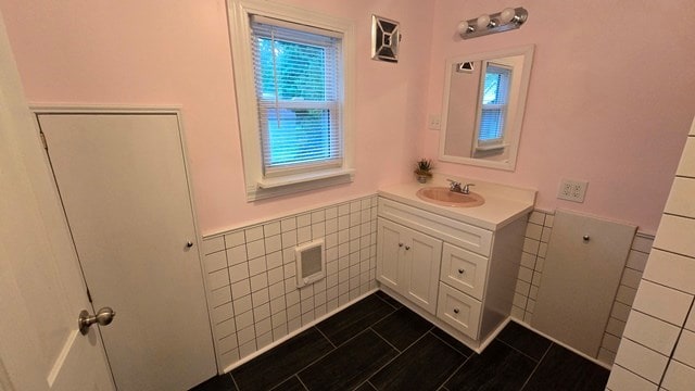 306 Broad St, Port Allegany, PA 16743 - bathroom featuring tile walls, vanity, and a wainscoted wall