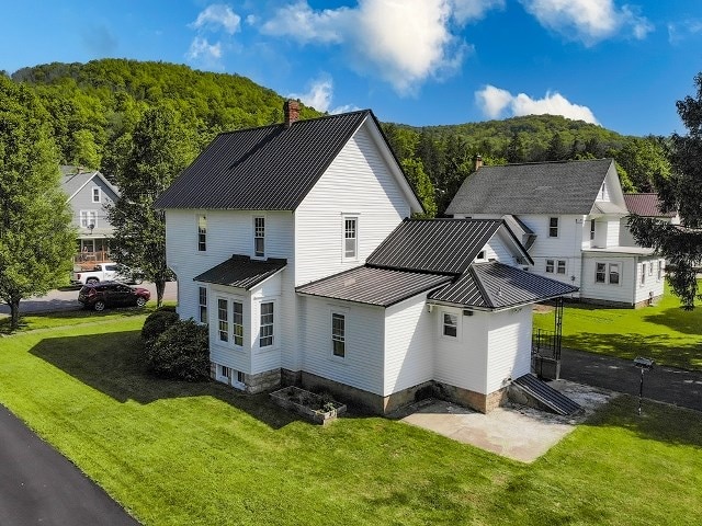 306 Broad St, Port Allegany, PA 16743 - back of property featuring a chimney, a standing seam roof, a lawn, and a metal roof